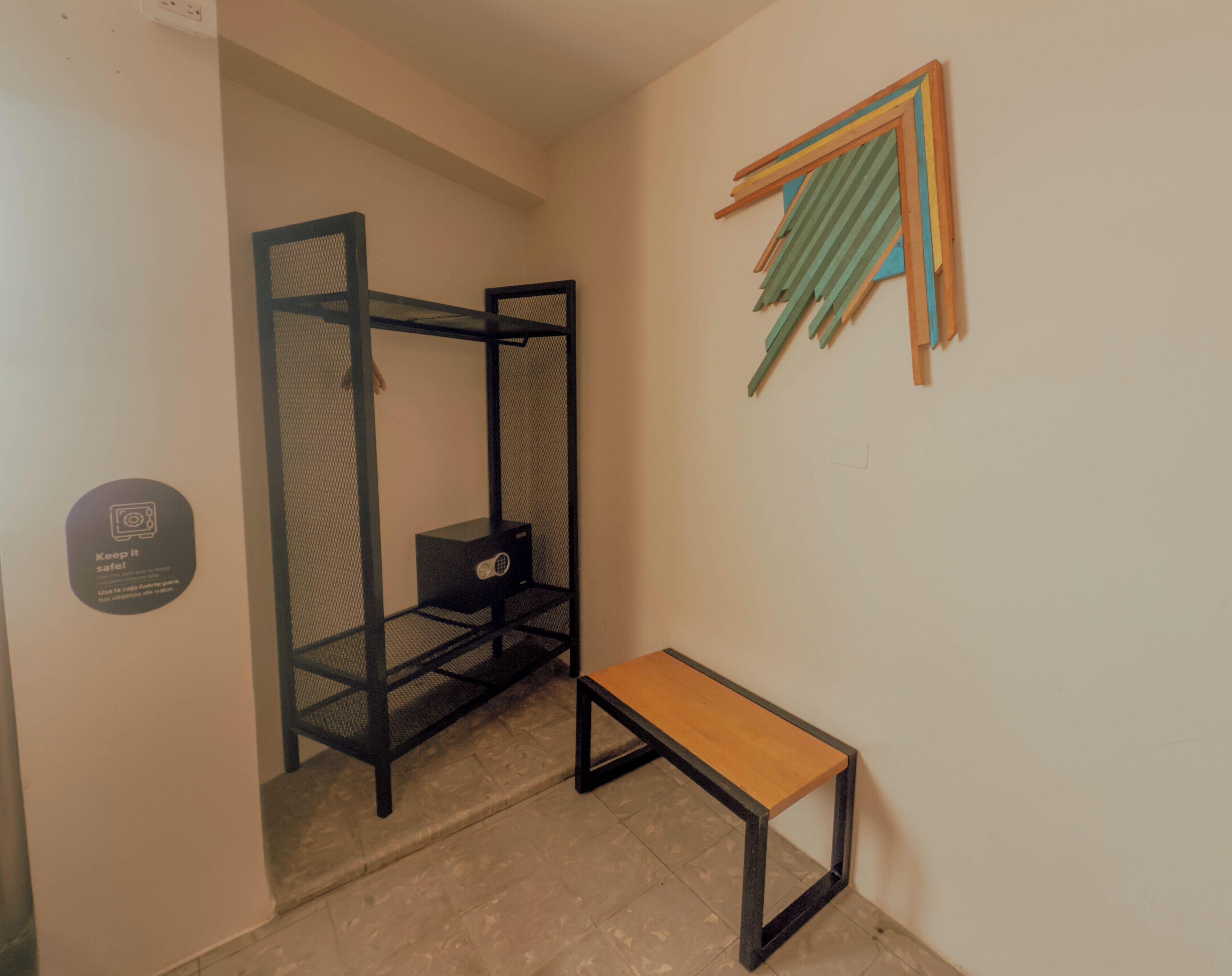 A compact room with a bunk bed, a small table, and a wall-mounted shelf.