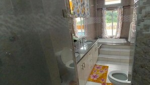 A bathroom with a toilet, sink, and shower area. - Union Hilltop Paradise Villas - Premium Poolside Villa with Scenic Views (Castries)