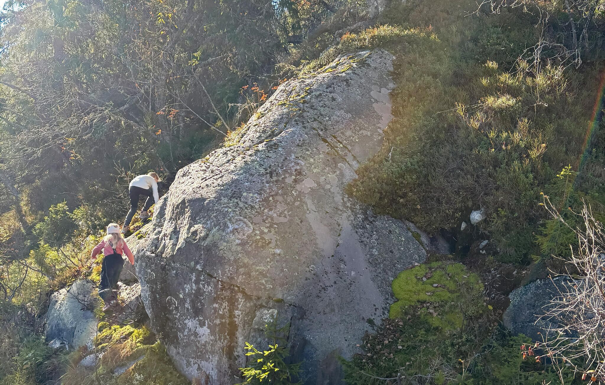 A rocky terrain with two hikers.