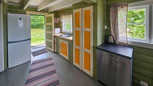 A compact kitchen with a refrigerator, a sink, and a kettle on the counter. - Amazing home in Svelvik with WiFi (Svelvik)