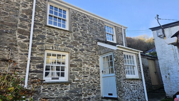 A stone building with two windows and a door. - Bay Cottage -  a cottage that sleeps 6 guests  in 3 bedrooms (Portloe)