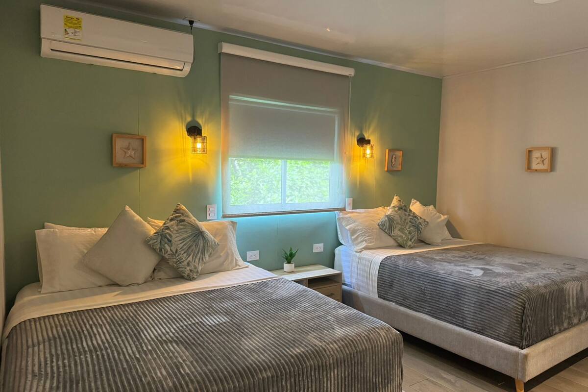 Family Quadruple Room, 2 Queen Beds, Private Bathroom | In-room safe, laptop workspace, blackout curtains, iron/ironing board