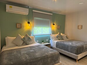 Family Quadruple Room, 2 Queen Beds, Private Bathroom | In-room safe, laptop workspace, blackout drapes, iron/ironing board