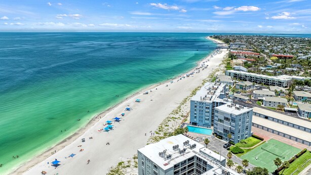 A coastal hotel with a beach view, multiple swimming pools, and a tennis court. - Dolphin Resort | Private Pool, Spa, Tiki Bar, Game Room & 3 Min Walk to Beach (Holmes Beach)