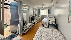 Una habitación de hotel compacta con cama, escritorio, televisor y armario.