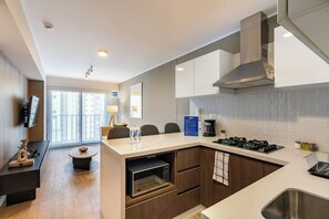 Fridge, microwave, coffee/tea maker, cookware/dishes/utensils