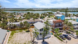 A coastal residential area with houses, a beach, and a view of the ocean.