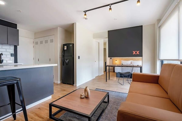 A modern apartment with a kitchen, dining area, and living room.