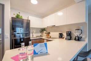 Fridge, microwave, stovetop, coffee/tea maker