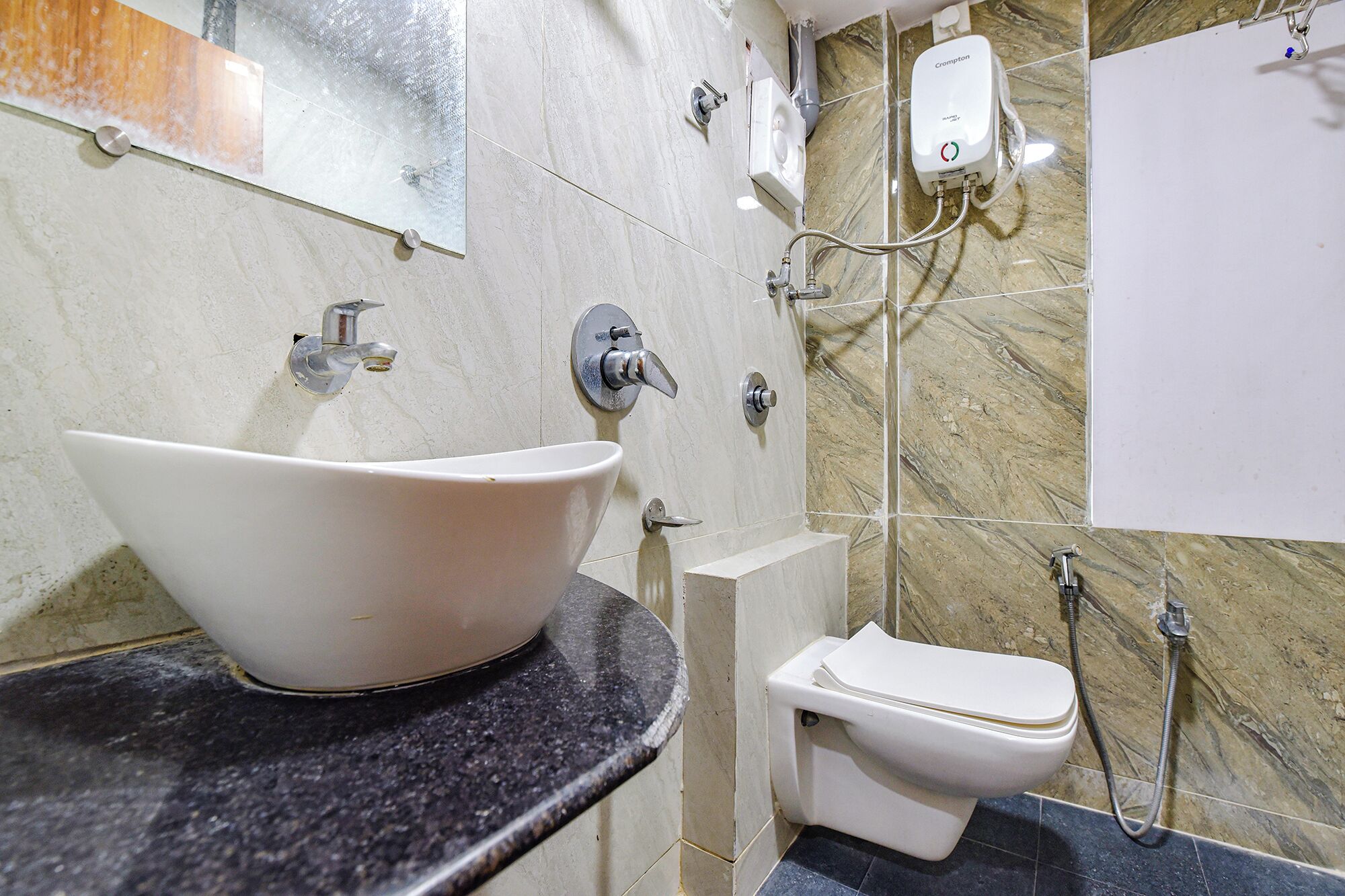 A bathroom with a white sink, a toilet, and a shower area.
