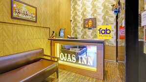 A reception desk with a sign reading "HOTEL DAS INN" and a "fab HOTELS" sign.