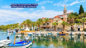 A marina with boats, a church, and a clear view of the sea.