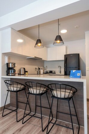 Fridge, microwave, stovetop, coffee/tea maker