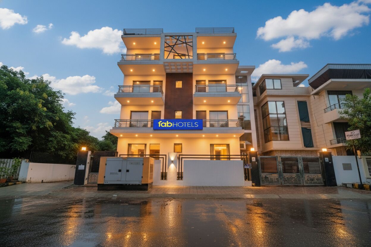 A multi-story hotel with a modern design, featuring balconies on each floor and a prominent entrance.
