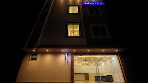 A hotel facade at night with illuminated windows and a sign reading "fab hotels". - Fabhotel Shri Ram Retreat (Mathura)