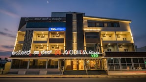 A multi-story hotel with a modern design, featuring a prominent sign for 'fabHOTELS' and 'AIODHYA Palace VEG'. - FabHotel Ayodhya Palace - Peenya (Bengaluru)
