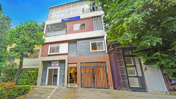 A multi-story building with a 'fab-hotels' sign, a 'Grand Stay Hotel' sign, and a gated entrance. - Fabhotel Grand Stay Ambedkar Nagar (Indore)