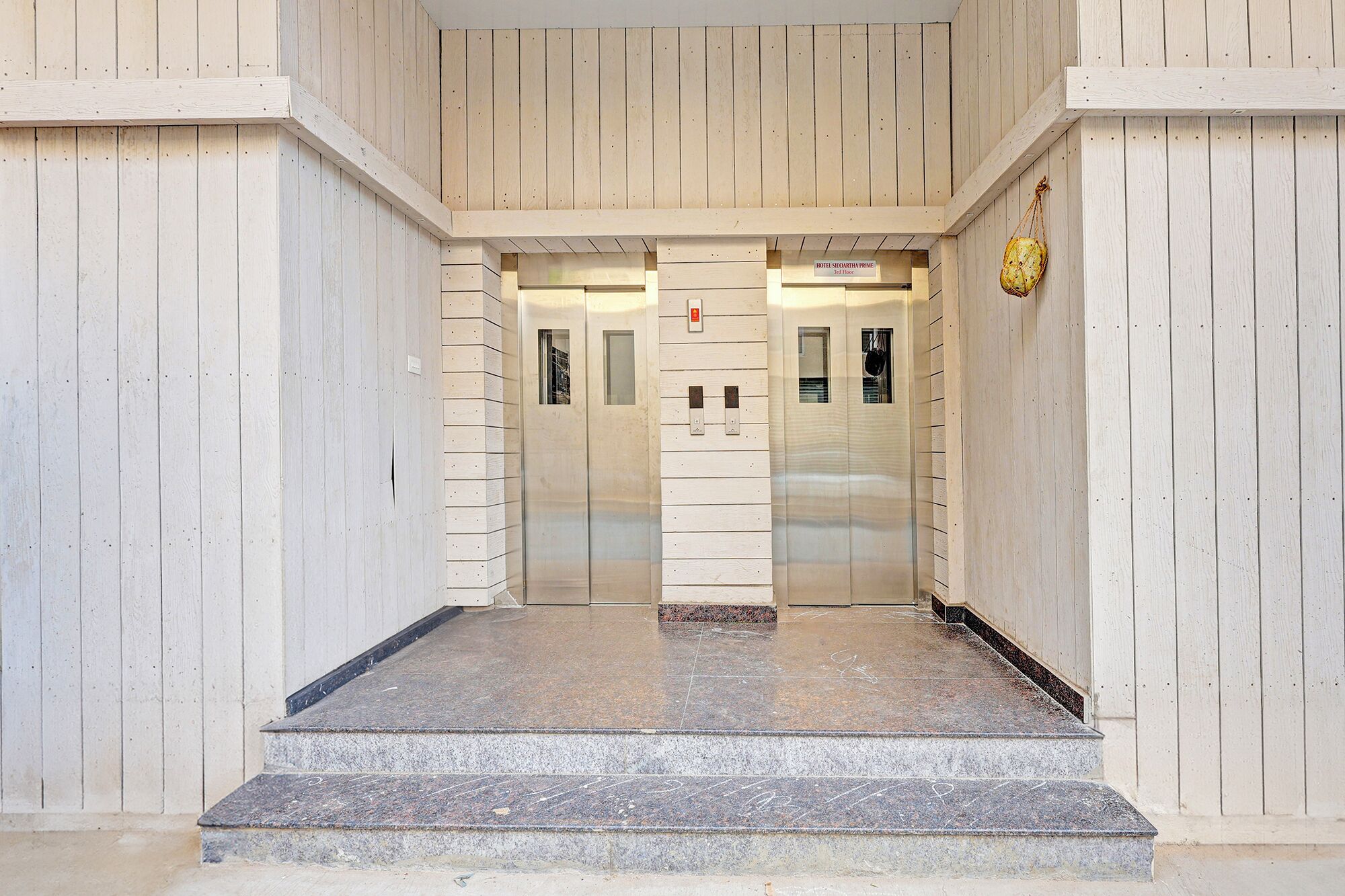 An elevator entrance with a sign indicating the third floor.
