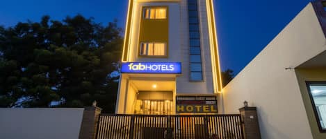 A modern building with a sign for 'fabHOTELS' and 'PABAIANG GUEST HOUSE & GUESTHOUSE HOTEL'.
