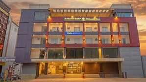 A modern hotel with a two-story structure, a prominent 'Fab Hotels' sign, and a view of the street at dusk. - FabHotel Millennials - Jigani (Anekal)