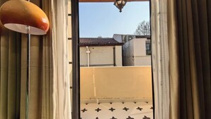 A room with a view through a window with curtains, a ceiling lamp, and a patterned wall. - Shanghai Hills & Zinn Sunshine bnb (Shanghai)