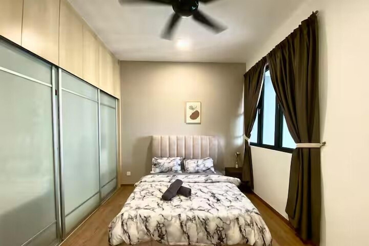 A bedroom with a bed, a ceiling fan, a window with curtains, and a wall-mounted artwork.