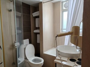 Deluxe Triple Room, City View | Bathroom | Hair dryer, slippers, towels, shampoo