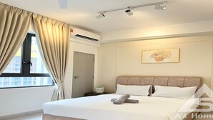 A modern bedroom with a large bed, beige curtains, an air conditioning unit, a bedside table with a lamp, and a framed artwork on the wall.