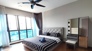A modern hotel room with a large bed, a bedside table, a mirror, and a view of the city. - Amerin Residence Mall Apartments (Seri Kembangan)