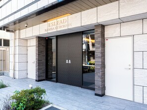 A modern building entrance with a sign reading 'ESLEAD NAMBAKUROMON'. - ESLEAD HOTEL Namba Kuromon (Osaka)