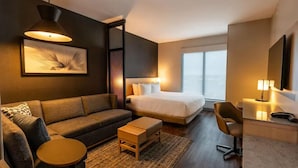 A modern hotel room with a large bed, a sofa, a small table, and a desk with a chair. - Hyatt Place Piedras Negras (Piedras Negras)