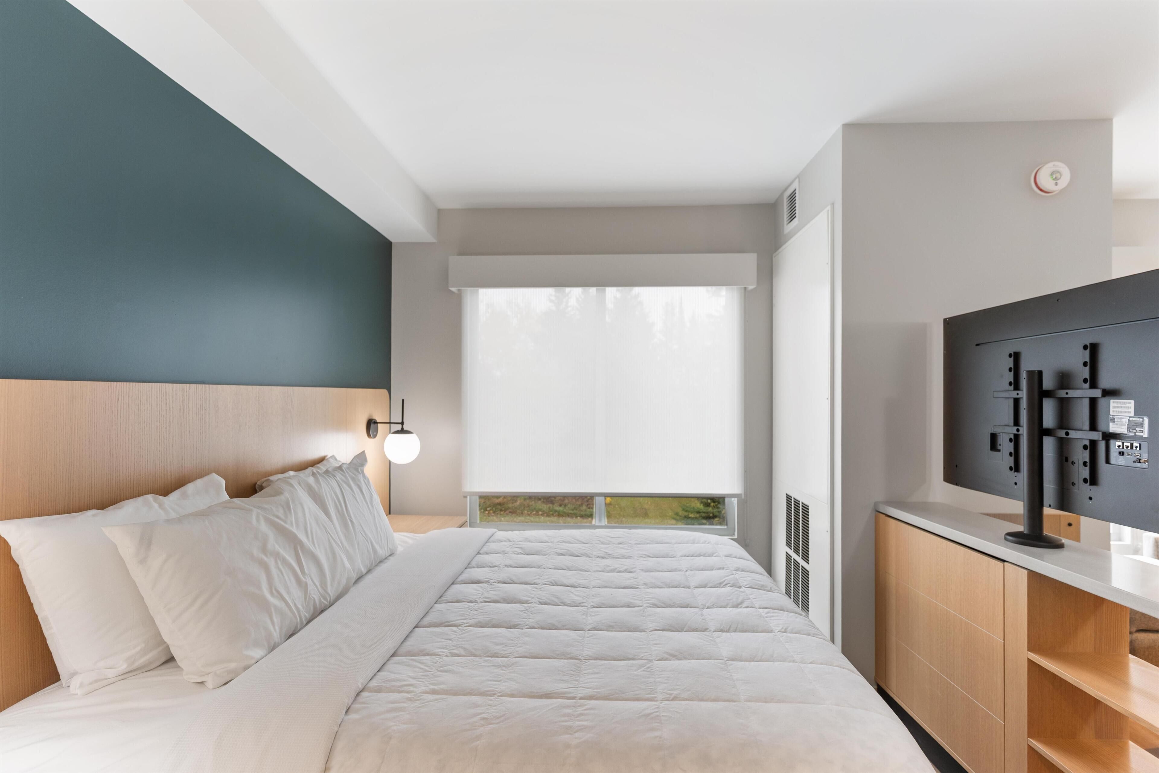 Desk, laptop workspace, blackout curtains, bed sheets