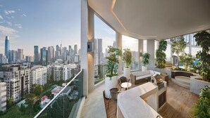 Eine moderne Wohnung mit Balkon und Blick auf die Stadt, ausgestattet mit einer Küchenzeile, einem Grill und Sitzgelegenheit.