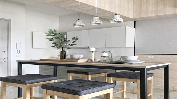 A modern kitchen with a central island, bar stools, pendant lighting, and a vase with greenery. - 28 Boulevard Residence KLCC Skyview (Ampang)