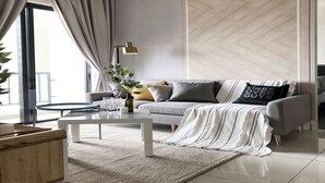 A modern living room with a grey sofa, a white coffee table, and a glass-top table. - 28 Boulevard Residence KLCC Skyview (Ampang)