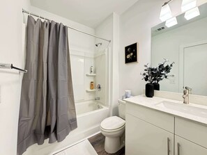 Shower, hair dryer, towels, shampoo