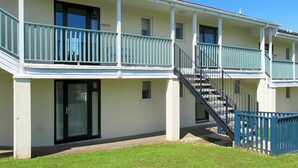 A multi-story building with balconies, a staircase, and a glass door entrance. - Willow Apartment - UK49303 (Woolfardisworthy, Clovelly)