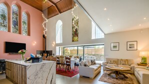 A spacious living area with a marble bar, dining setup, and a cozy seating area.