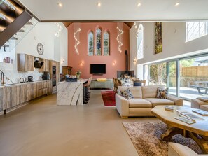 A spacious living area with a kitchen, dining space, and a large window offering a view of the outdoors. - 5 bedroom accommodation in Duns (Duns)