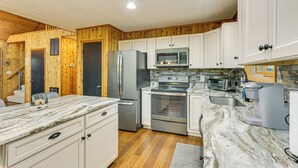 A modern kitchen with white cabinets, stainless steel appliances, and a marble countertop. - Serene Mountain Home: 11 Mi to Gettysburg (Fairfield)