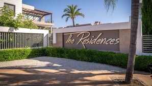 A modern building with a sign reading "The Residences".