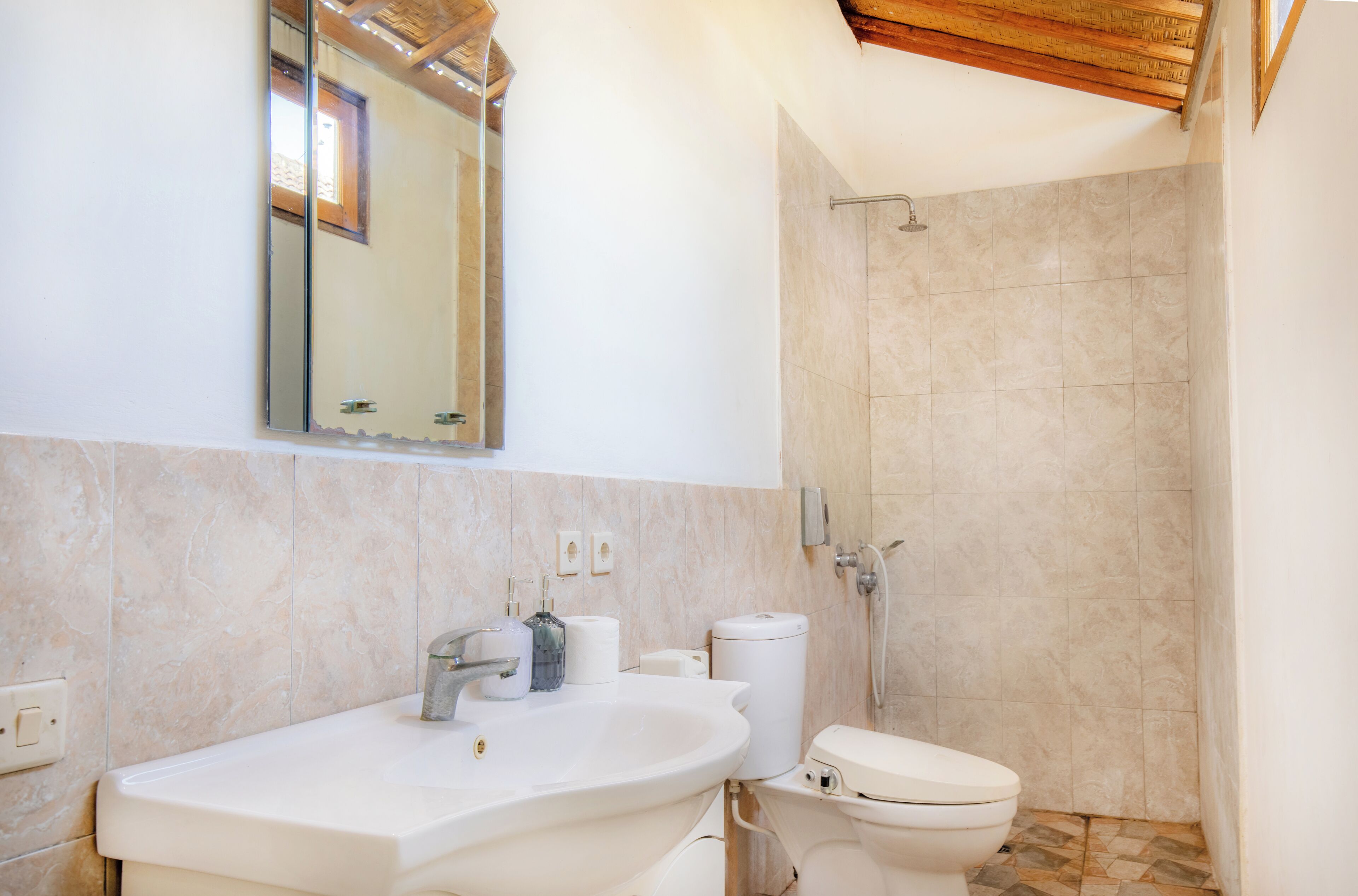 A bathroom with a sink, toilet, and shower.