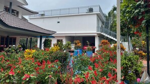 A two-story building with a covered patio area and a staircase leading to an upper floor.