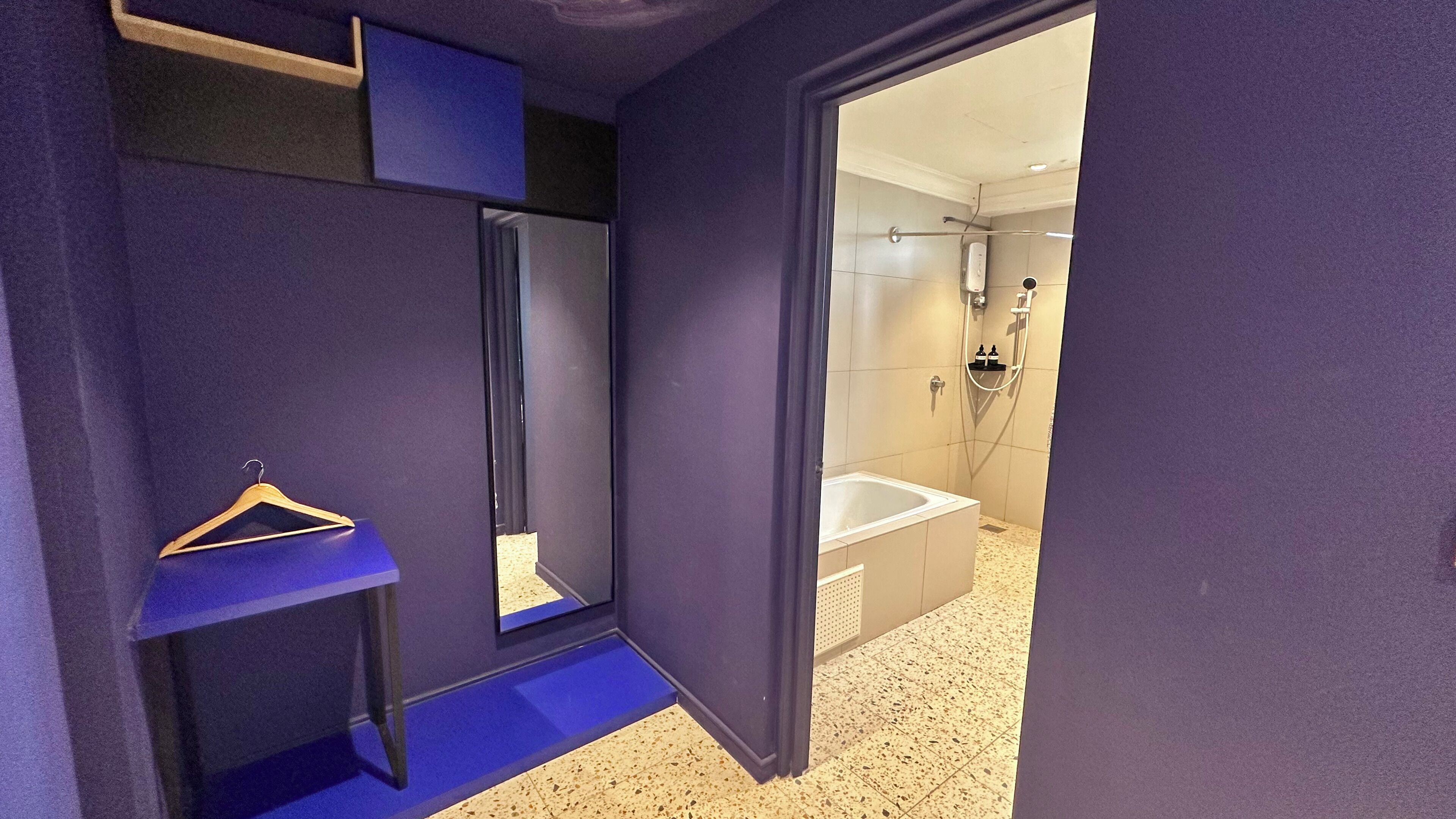 A bathroom with a shower, a sink, and a mirror.