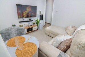 Deluxe Apartment, City View | Living area | 32-inch Smart TV with digital channels