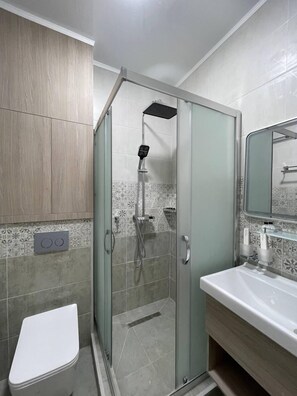 Shower, hair dryer, towels, soap