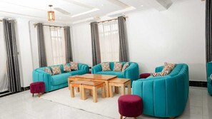 Family Apartment, City View | Living area | 32-inch Smart TV with digital channels