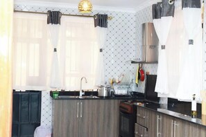 Family Apartment, City View | Private kitchen | Fridge, microwave, cookware/dishes/utensils