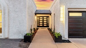 A modern building with a number 7730 displayed on the wall, a gated entrance, and a pathway leading to the entrance. - NEW|The Bungalow @ Old Town|Al-Fresco Living|Pool (Scottsdale)