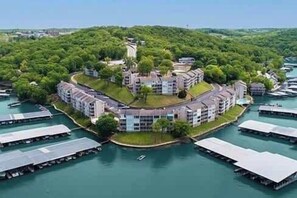 A waterfront hotel with multiple buildings, a central courtyard, and boats docked around the property.
